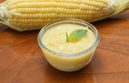 fresh corn cream soup on wood tableの写真素材