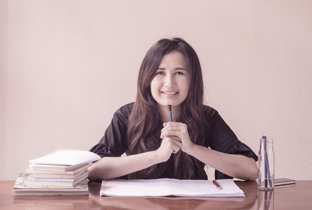 asian Woman is working and reading a book with retro filter