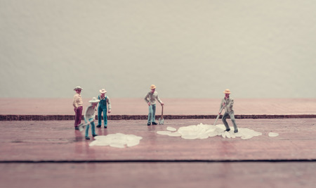 Miniature worker man working together about rice seed with retro filterの写真素材