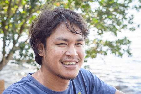 young asia man on outdoor at sea scape natural backgroundの写真素材