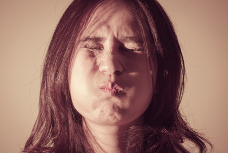 portrait funny asia woman with light shadow on wall with retro filter