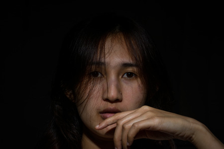 Portrait of asia woman  in darkness with soft light