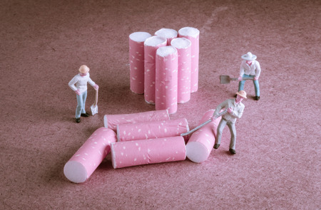 cigarette butt with miniatures workers on wood with retro filterの写真素材