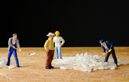close up Miniature worker man with rice seed foodの写真素材