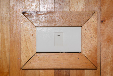 wood wall texture with light switchの写真素材