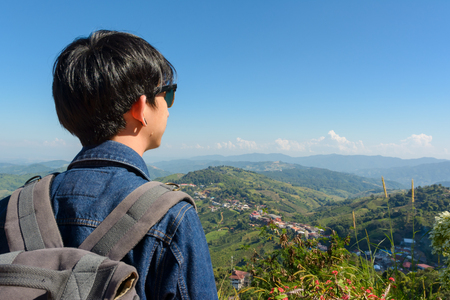 Tourist man relax at terrace outdoor on mountain backgroundの写真素材