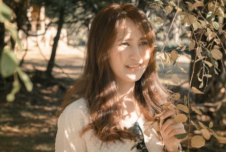 portrait asia Woman in a park outdoor with retro filter