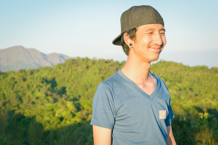 portrait man smile and standing on top of mountain with retro filterの写真素材