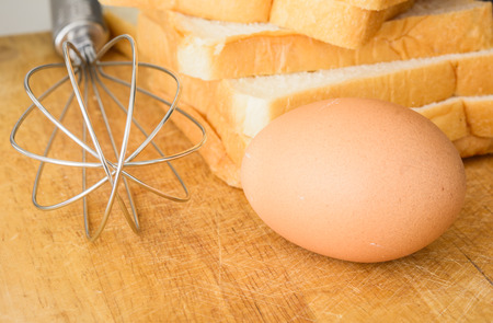close up whisk ,egg and sliced breadの写真素材
