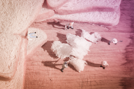 miniature people worker on sliced bread (work on bread) with retro filterの写真素材