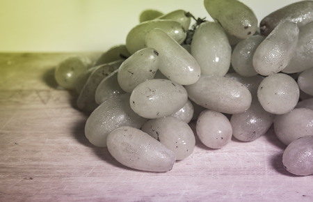 green grapes ripe fruit  on wood background with retro filterの写真素材
