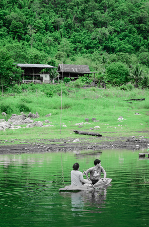 asia men driving with kayak on natural forest river (water sport) with retro filterの写真素材