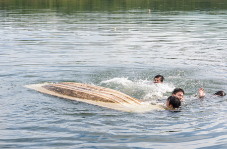 Kayak capsizing with asia man at natural water river (small boat)の写真素材