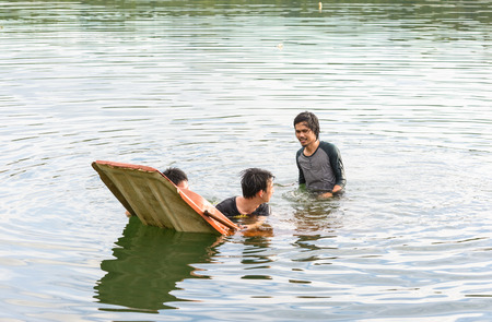 Kayak capsizing with asia man at natural water river (small boat)の写真素材