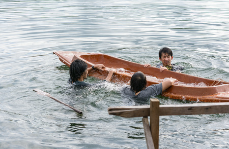 Kayak capsizing with asia man at natural water river (small boat)