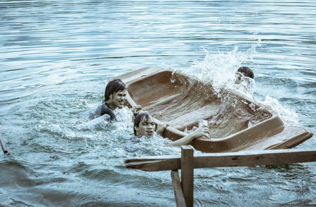 Kayak capsizing with asia man at natural river (small boat) with retro filterの写真素材