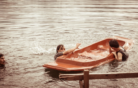 Kayak capsizing with asia man at natural river (small boat) with retro filterの写真素材