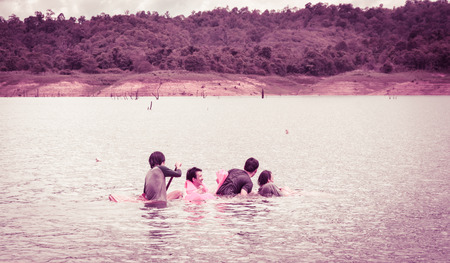 men swimming and Life jacket on natural river (asia man) with retro filter