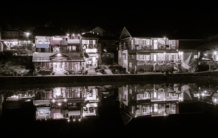 night view  small village house and lake nature with retro filterの写真素材