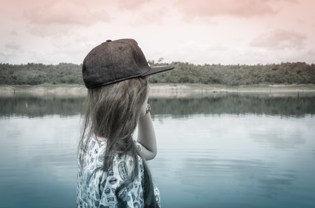 relaxing young asia woman near river water nature outdoor with retro filterの写真素材