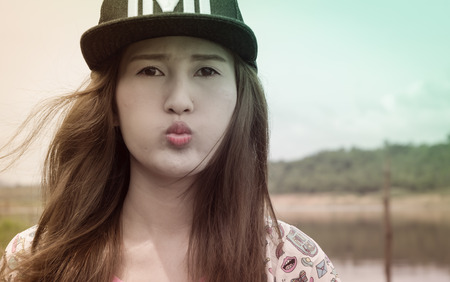 relaxing young asia woman near river water nature outdoor with retro filterの写真素材