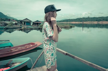relaxing young asia woman near river water nature outdoor with retro filterの写真素材