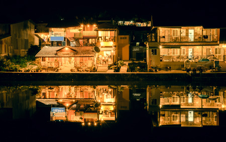 night view  small village house and lake nature with retro filterの写真素材