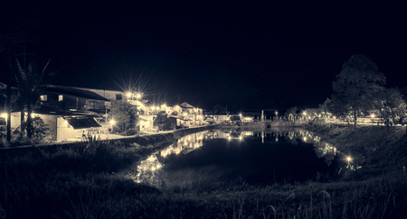night view  small village house and lake nature with retro filterの写真素材