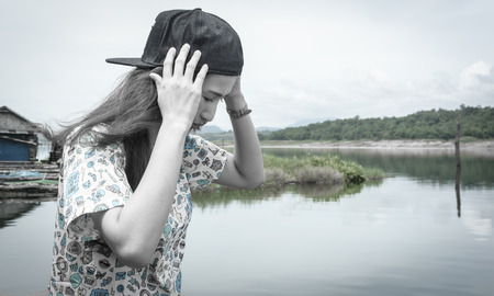 relaxing young asia woman near river water nature outdoor with retro filterの写真素材