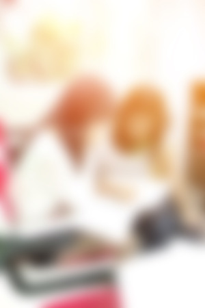 blurred background of talking working people in small cafeの写真素材