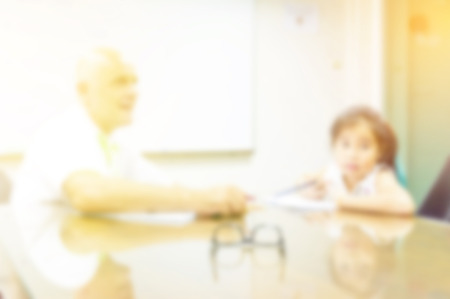 blurred background of child learning education in class room with teacherの写真素材