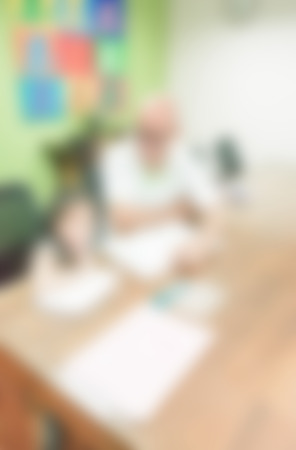 blurred background of child learning education in class room with teacherの写真素材