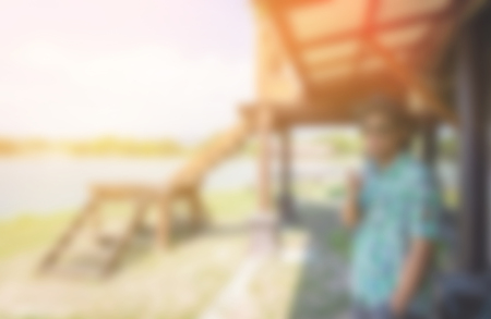 blur background of man relaxing on lake river outdoorの写真素材