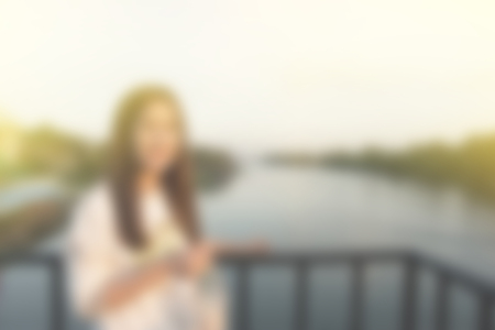 blur background of woman alone on natural lake riverの写真素材