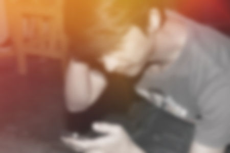 blur background of man play smart phone at indoorの写真素材
