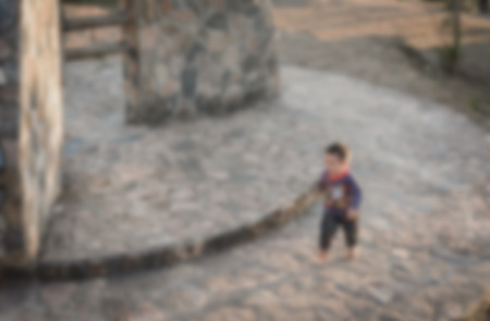 blur background of child run and play on play park outdoor