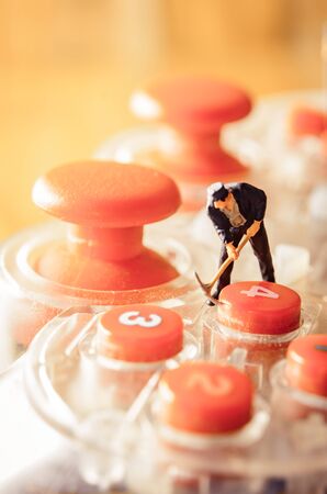 old game controller with miniature figure worker man at repair and work. with vintage filter