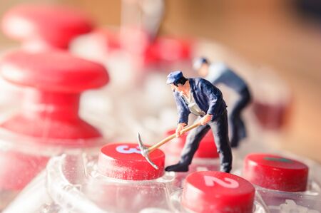 old game controller with miniature figure worker man at repair and work. with selective focusの写真素材