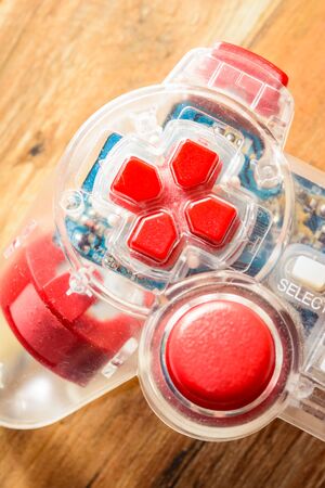 close up old game controller on wood table background