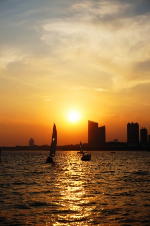 city sea boat sunset at china qingdaoの写真素材