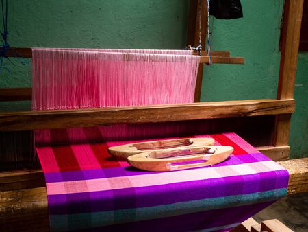 Traditional Honduran loom with pink and purple clothの写真素材