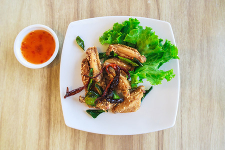 Fried chicken wings with sauceの写真素材