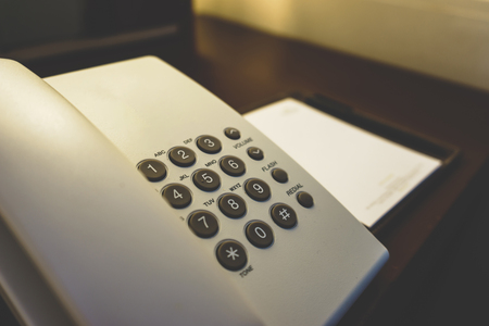 Telephone and Notebook on Table