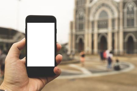 Hand on smartphone Blank Screen on Blur backgroundの写真素材