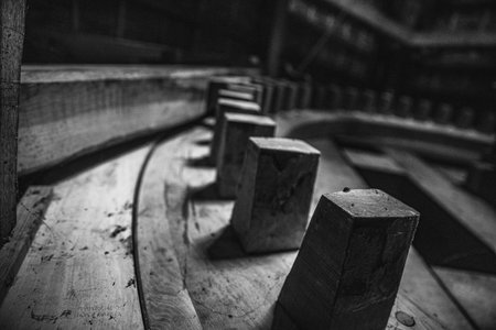 Close up black and white image of a wooden part.
