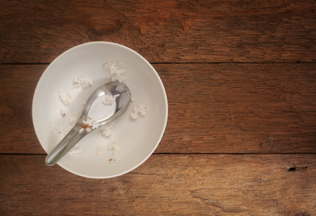 White ceramic bowl on wood background, Top view, Still lifeの写真素材