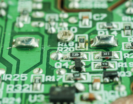 Closeup of an electronic printed broken circuit board with many electricalの写真素材