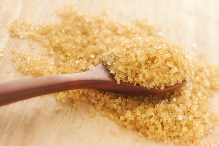 Sugar in a wooden spoon on wood background, Selective focusの写真素材