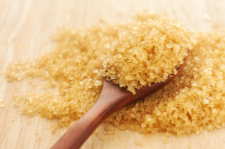 Sugar in a wooden spoon on wood background, Selective focusの写真素材
