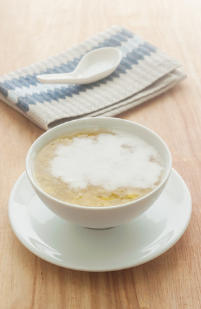 Soup made from corn with coconut milk on wooden backgroundの写真素材